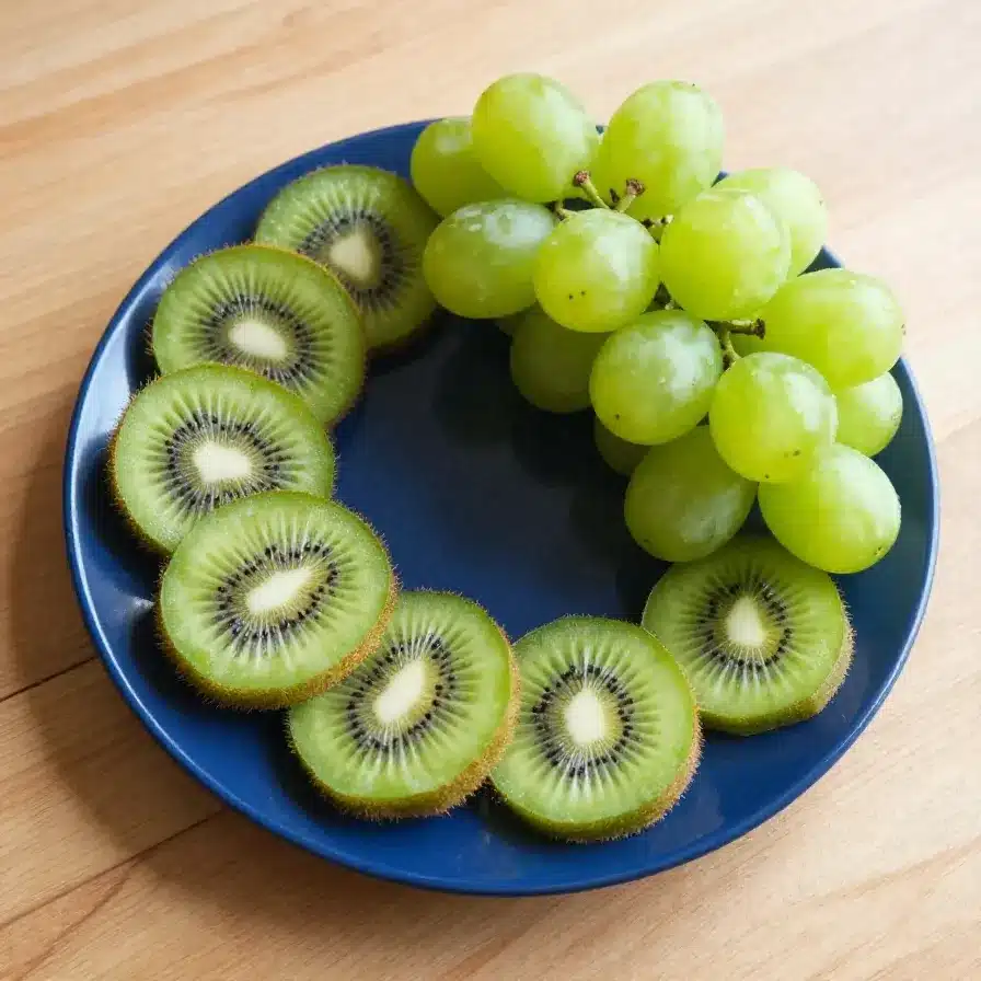 A creative food art featuring a kiwi turtle made from sliced kiwi fruit, perfect for kids' snacks.